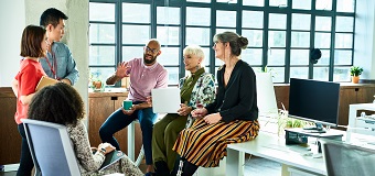 Team of workers sharing ideas at a desk