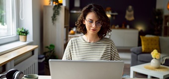 Caucassian woman working on laptop at her home office