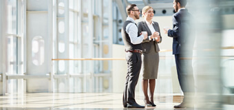 Three people in an office building